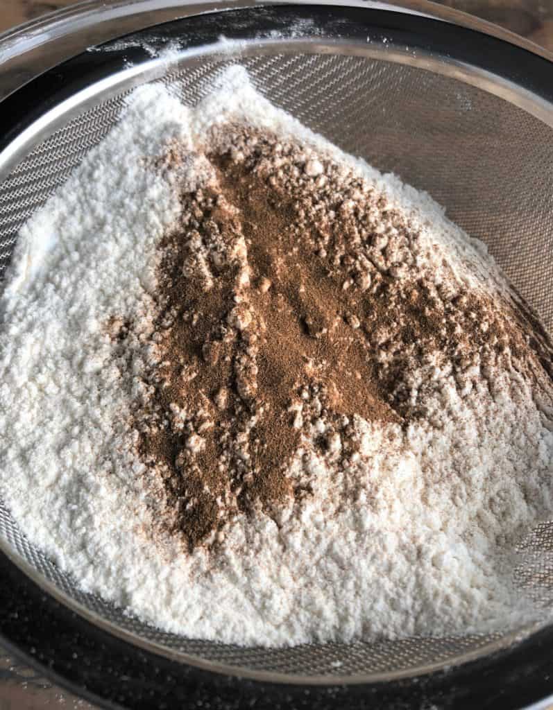 flour and cinnamon in a sieve