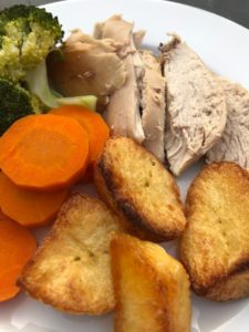 roast chicken roast potatoes carrots and broccoli on plate