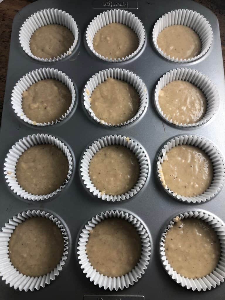 banana muffin mixture in muffin cases in a muffin tray
