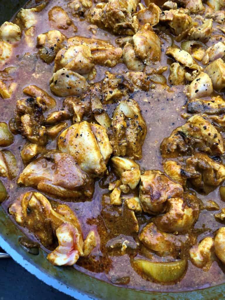 chicken korma sauce simmering in pan