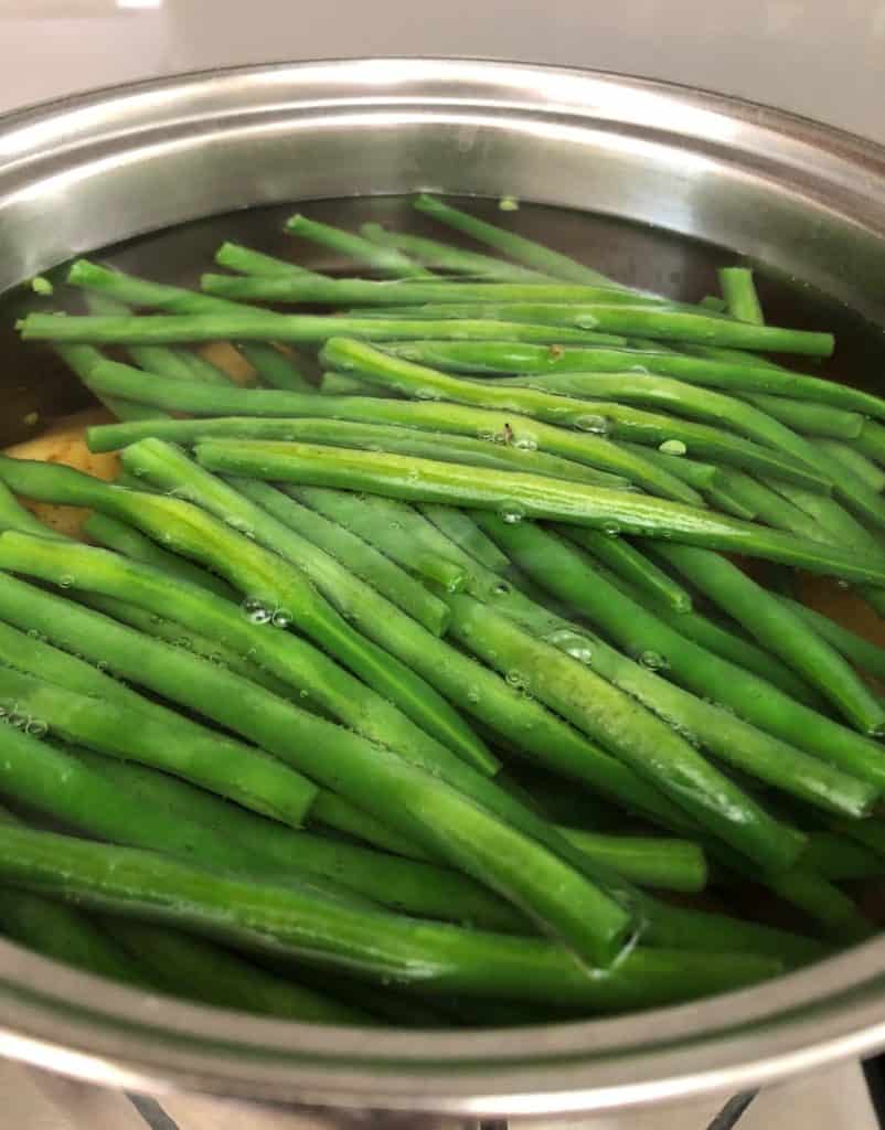 runner beans and potatoes in pan