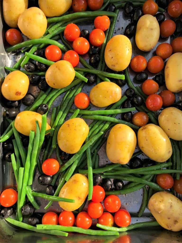 runner beans black olives tomatoes potatoes in roasting tray