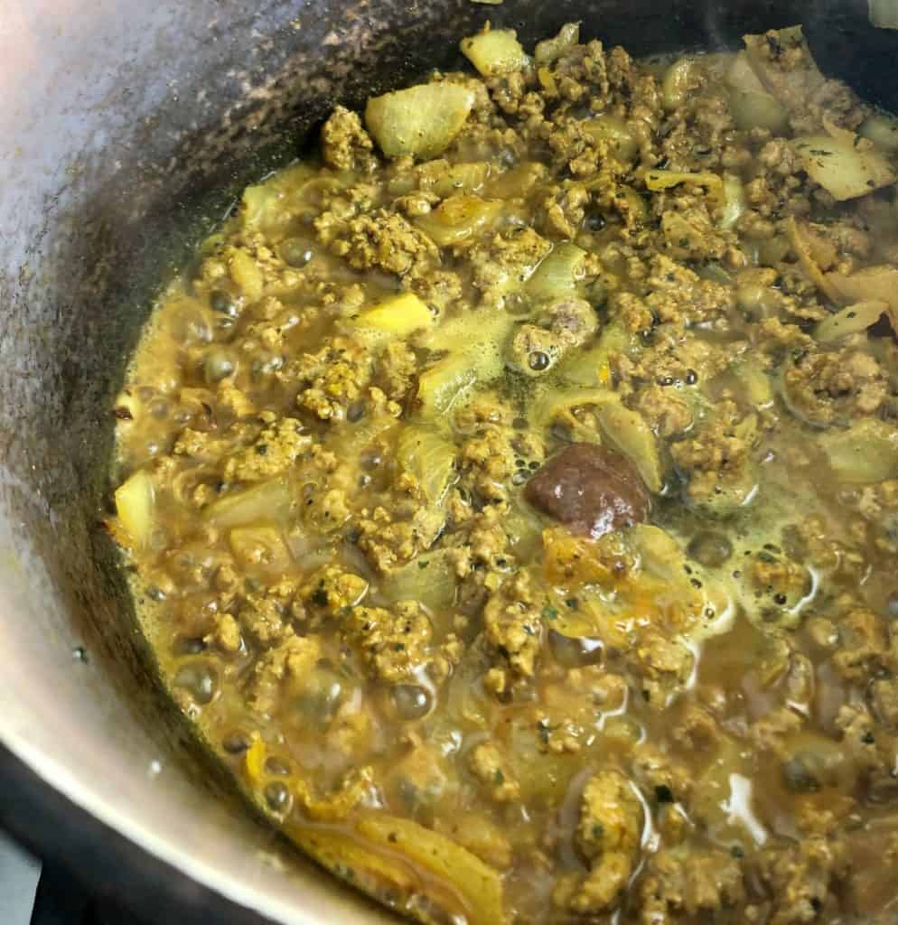 lamb mince onions spices stock in pan