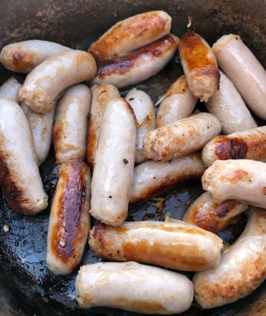 sausages frying in a pan