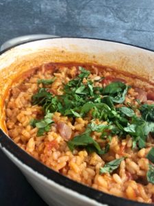 Tomato and Basil Risotto in dish fresh basil sprinkled on top
