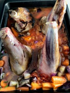 braised lamb shanks in tomato sauce ready for oven