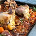 lamb shanks in tomato and wine sauce in tray