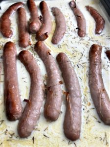 toad in the hole batter over sausages sprinkled with thyme