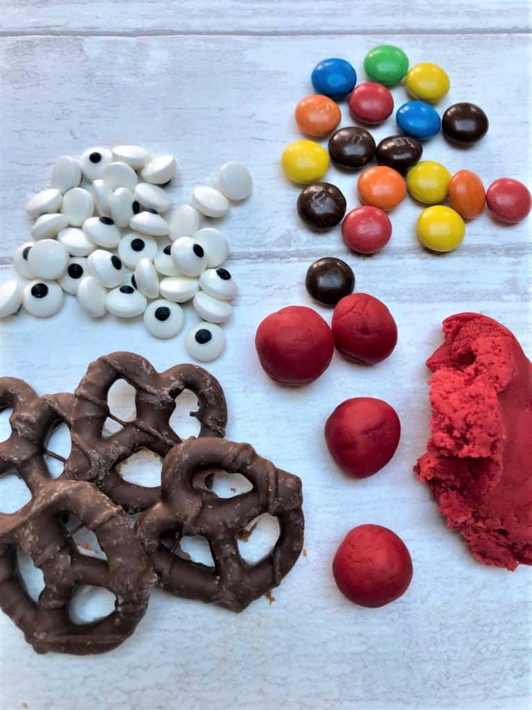 Gingerbread biscuit decorations pretzels candy eyes m&m's red icing
