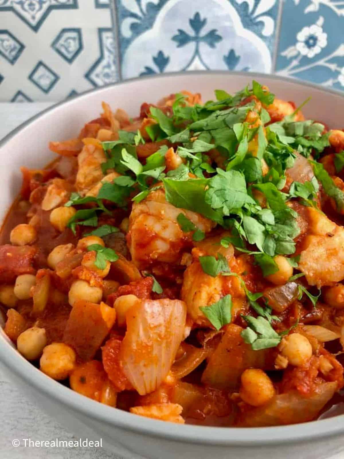 Fish and chickpea stew with sprinkling of fresh parsley