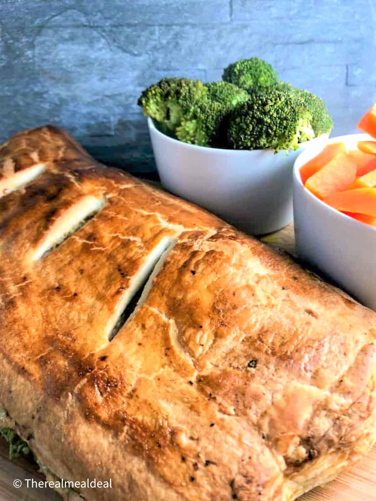 salmon en croute large parcel cooked with broccoli and carrots side dish