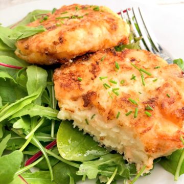 salmon fishcakes showing inside of mash, flaked fish and chives