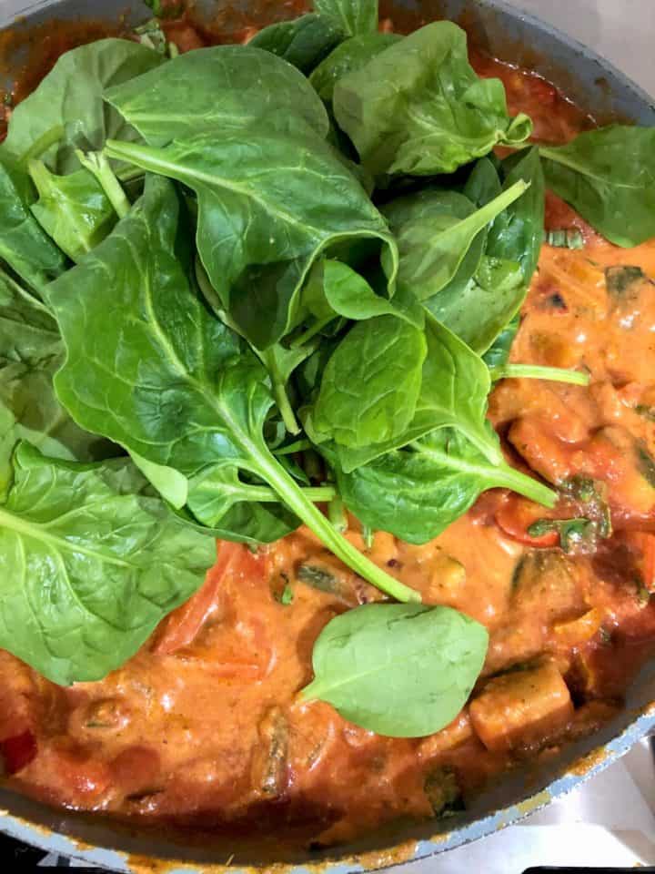 fresh spinach added to pasta bake sauce
