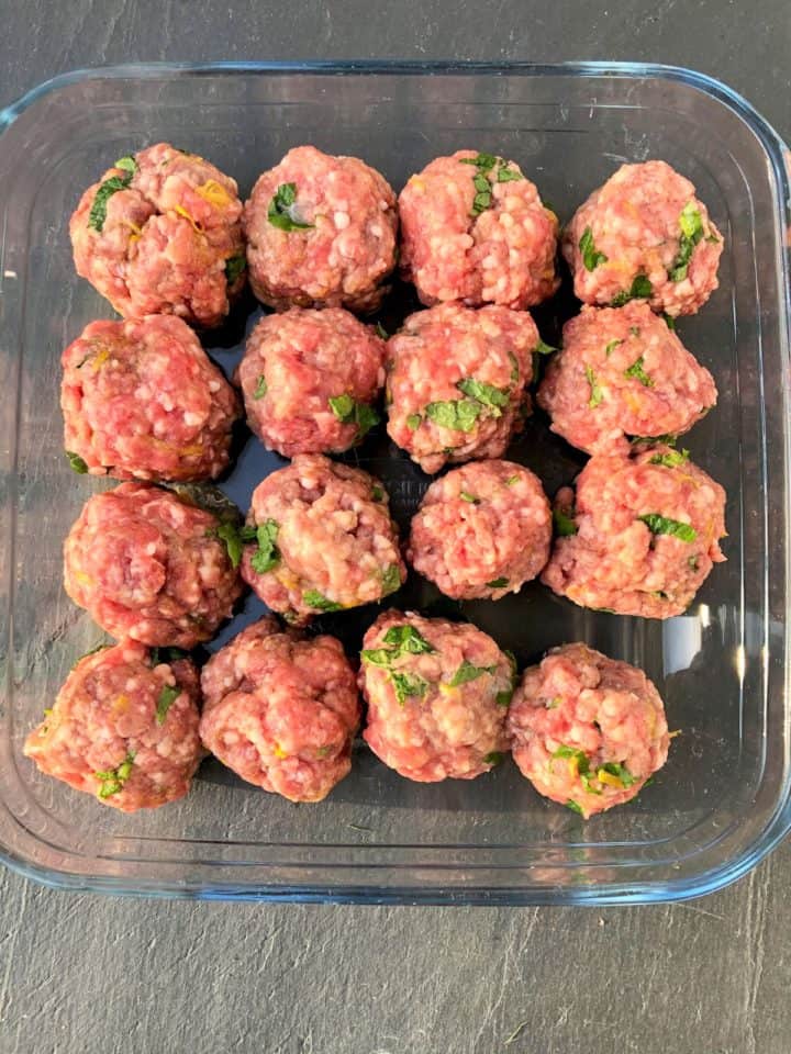 lamb meatballs in glass dish ready for oven