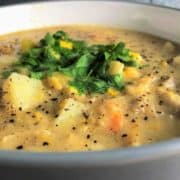 chowder with prawns smoked haddock leeks sweetcorn and potato in bowl topped with fresh parsley