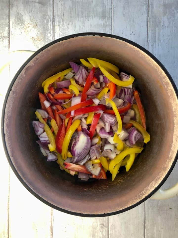diced red onion and peppers in casserole dish