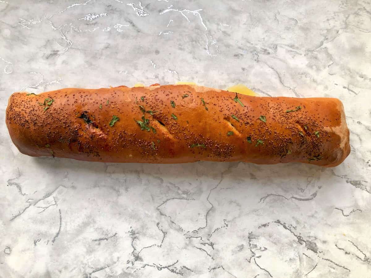 baked stromboli pizza roll ready for cutting