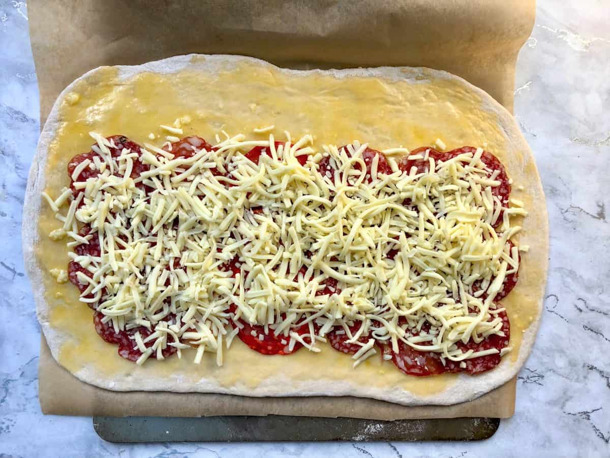 dough topped with meats and cheese