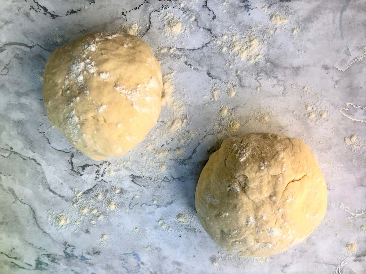 two balls of pizza dough on work surface