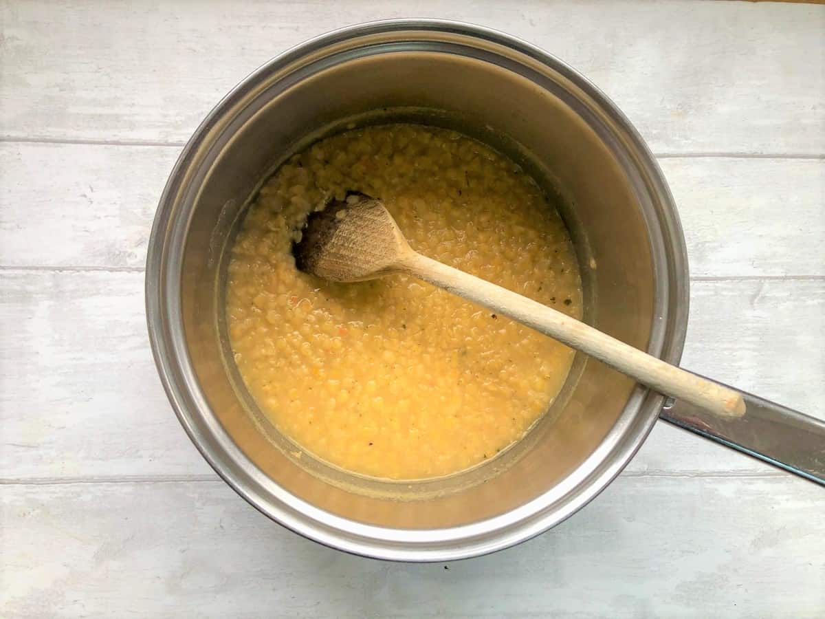 red lentils simmering in vegetable stock in a pan