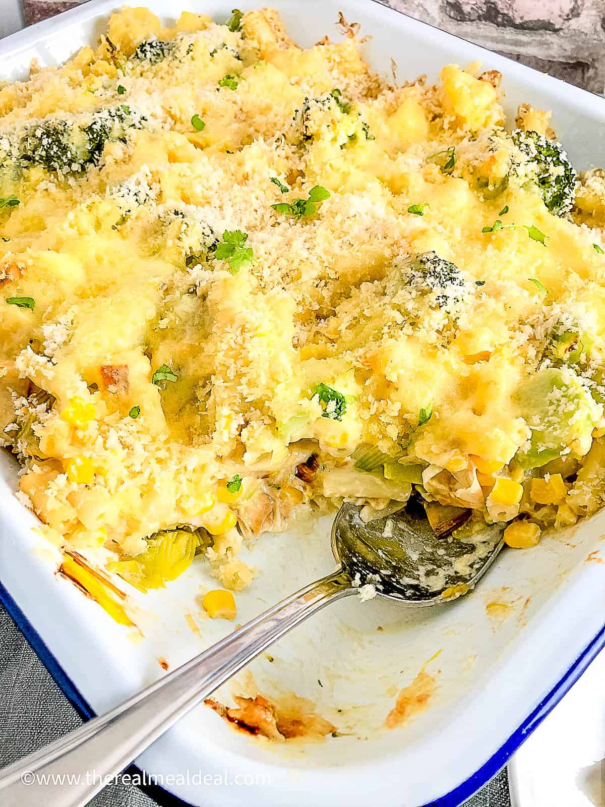 baked macaroni cheese in dish portion removed