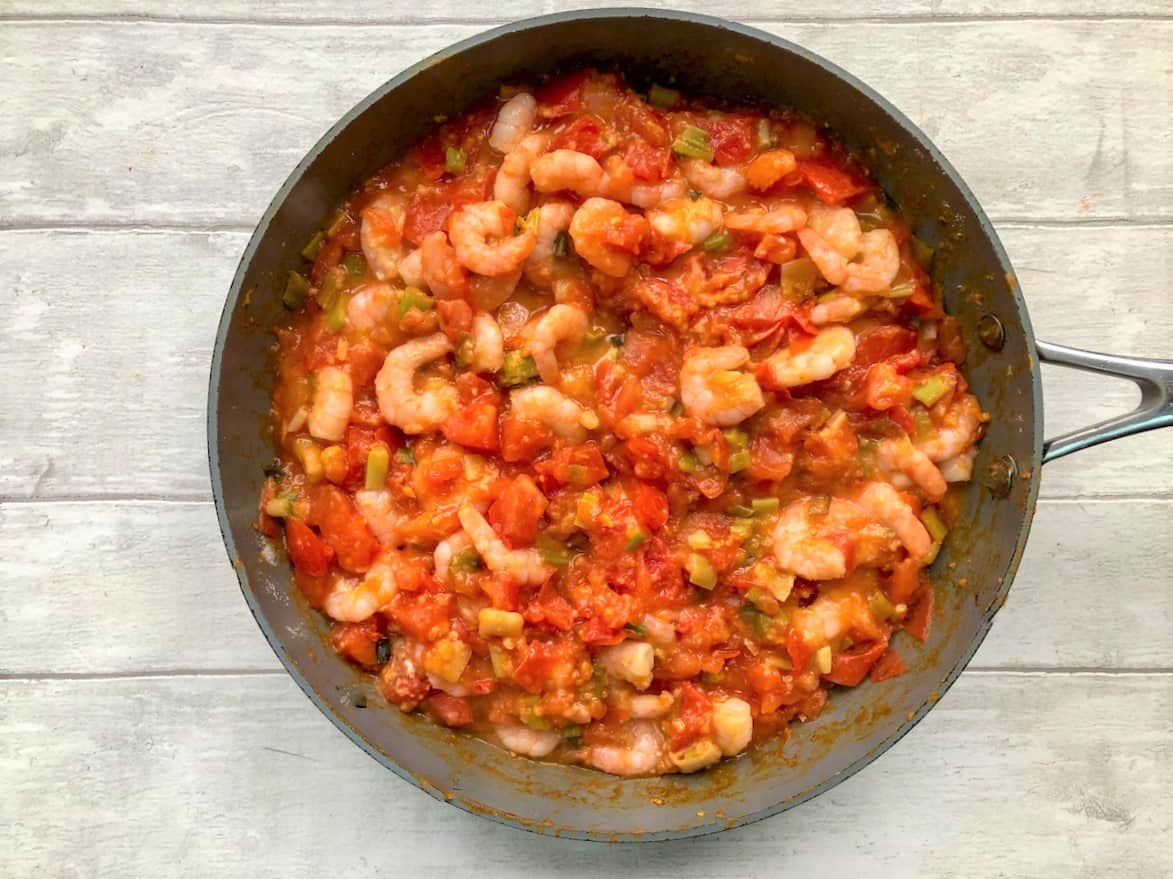 prawns added to tomatoes and onions in pan