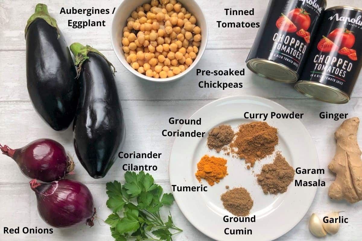 labelled image of ingredients for roasted aubergine and chickpea curry without coconut milk