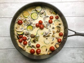 stock and cream added to pan with mushrooms courgette and tomato.