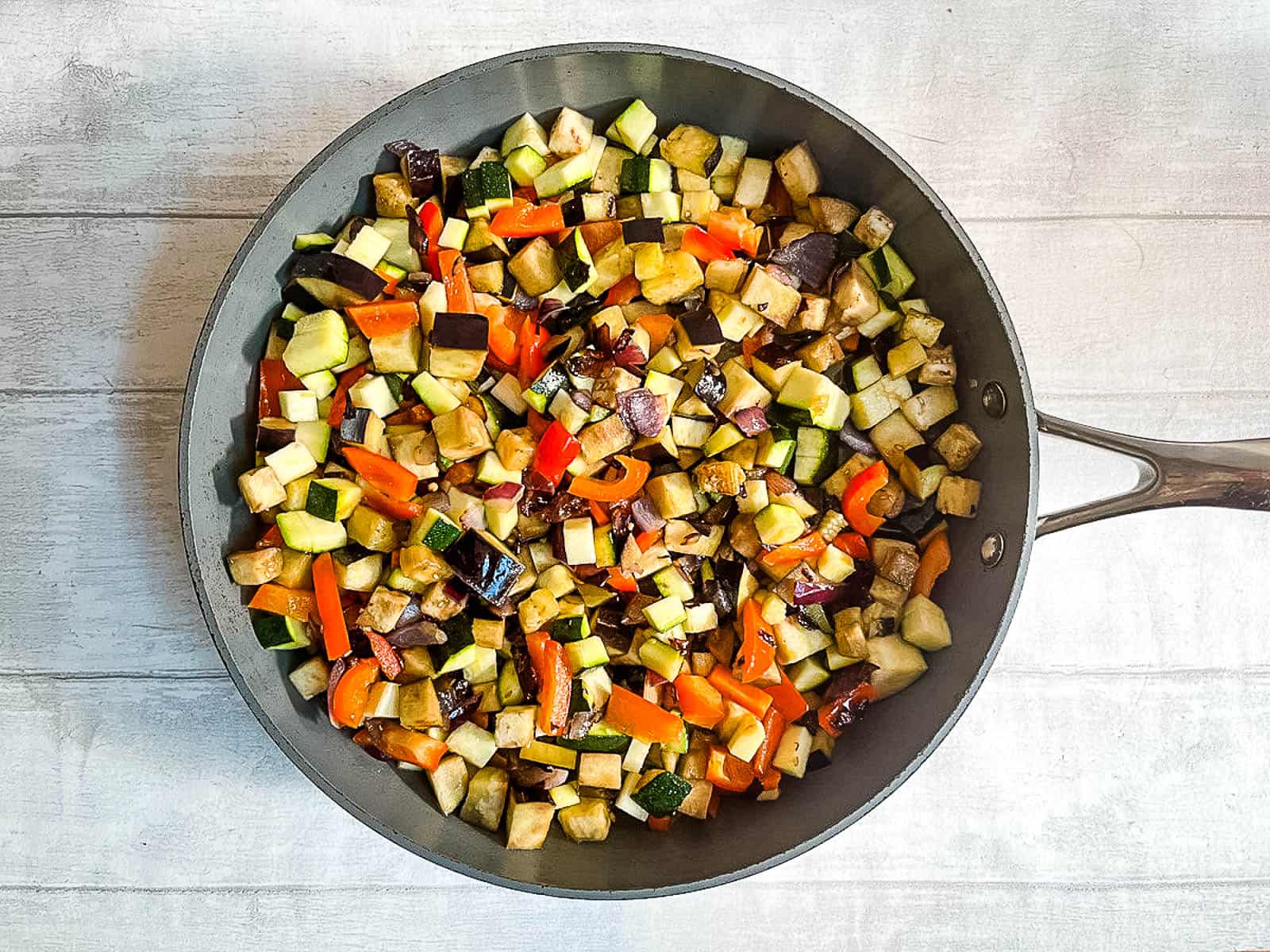 diced aubergine, courgette, red pepper and red onion in large frying pan