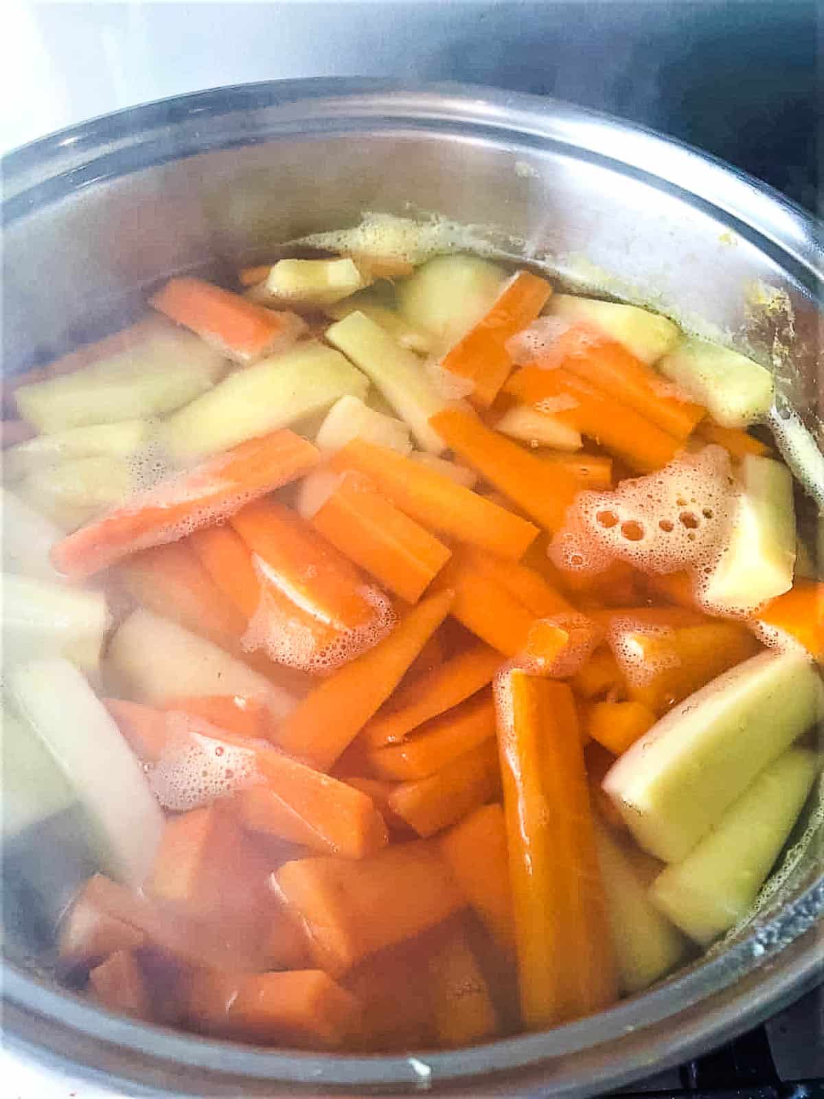 sliced carrots and parnips in pan.