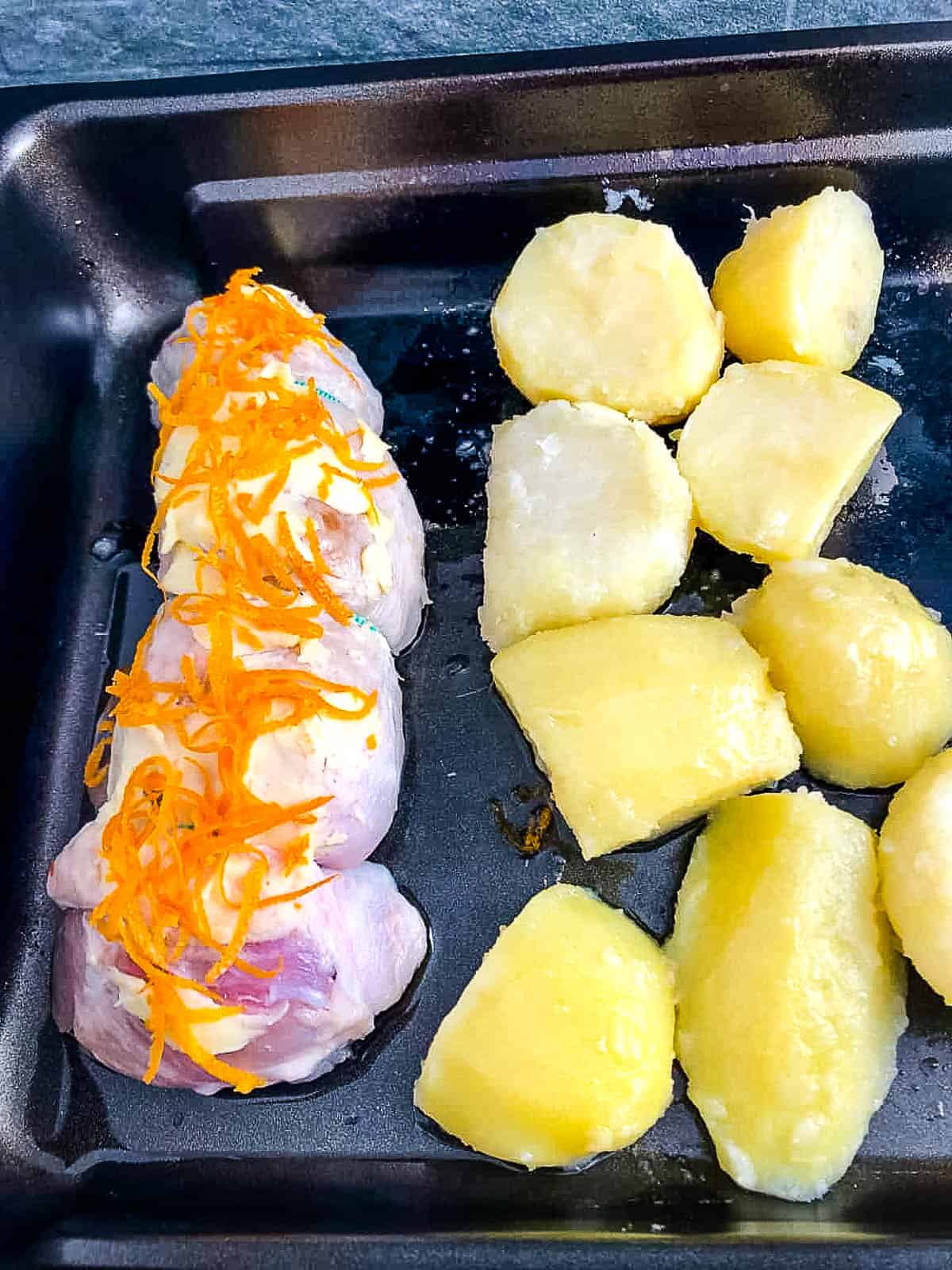 turkey breast and potatoes in tray.