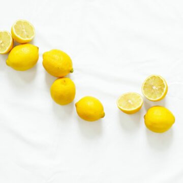 whole lemons and lemon halves on a white background