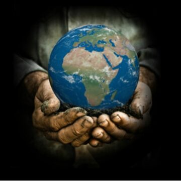 gardeners hands holding a globe on black background
