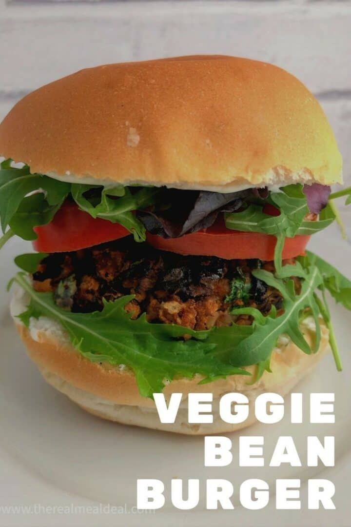 Red Bean burger in a bun with sliced tomato and lettuce