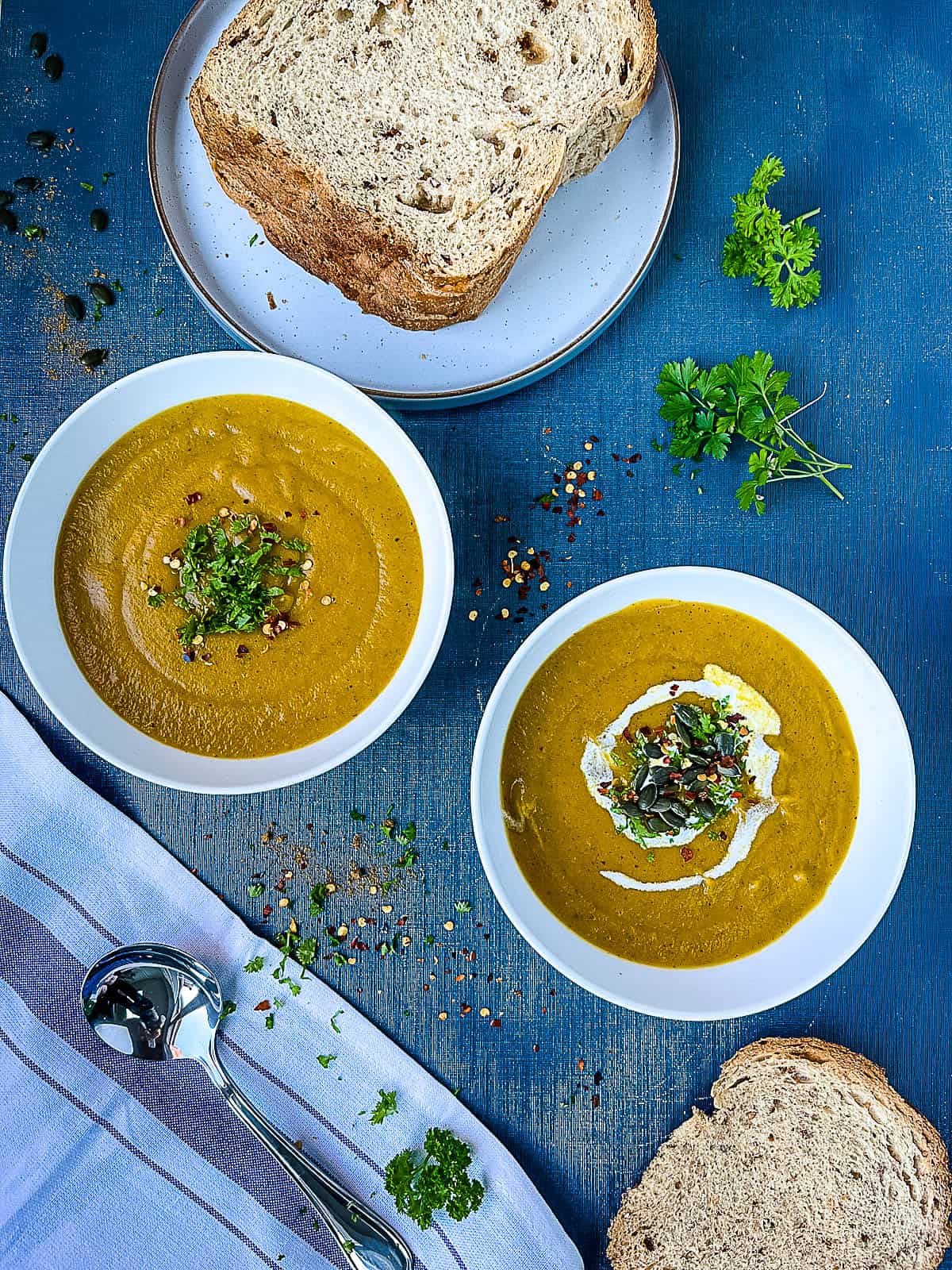 Carrot Carrot and Courgette Zucchini Soup served in bowls with a side of bread
