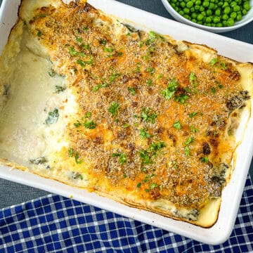 cod mornay baked with portion removed and side of peas