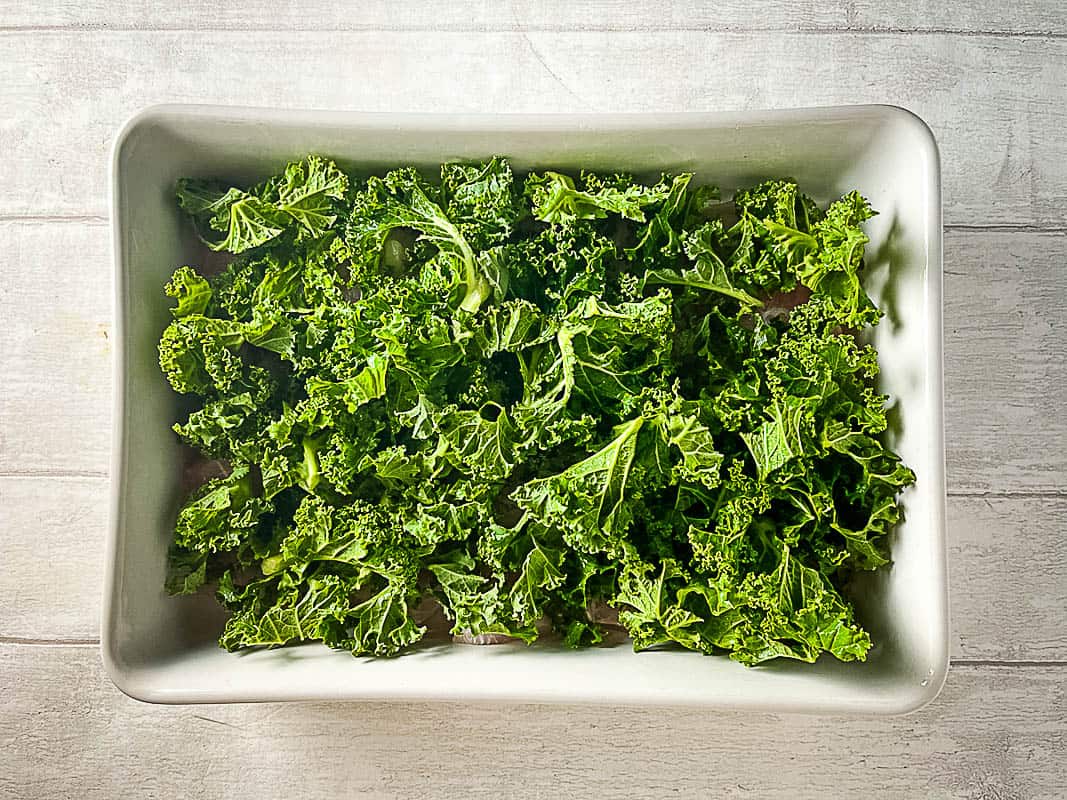 kale over fish in ovenproof dish