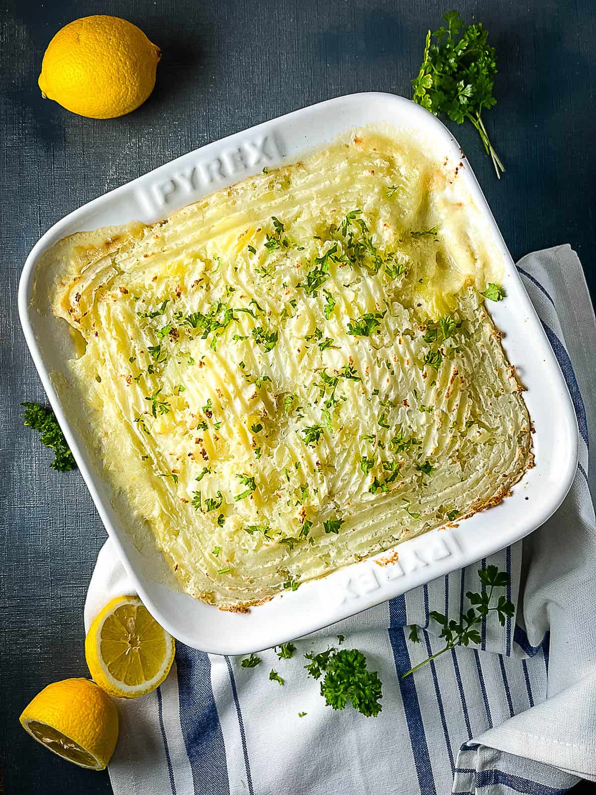 oven baked fish pie with leeks topped with fresh parsley