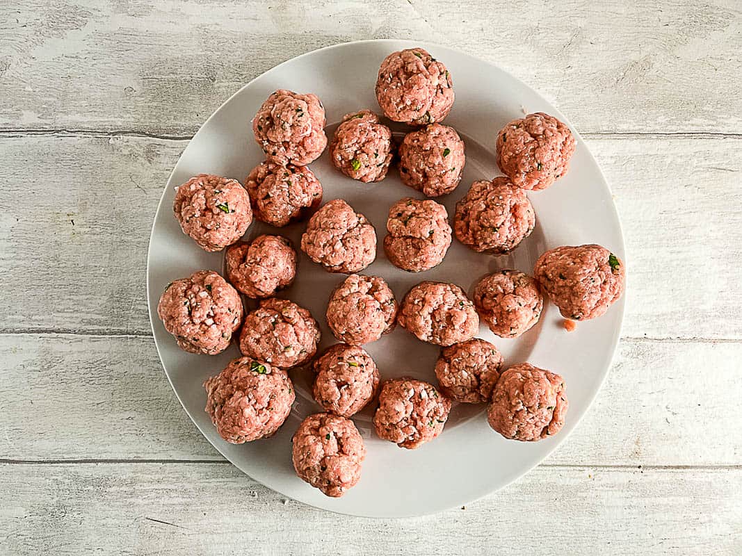 raw pork meatballs or patties on a plate