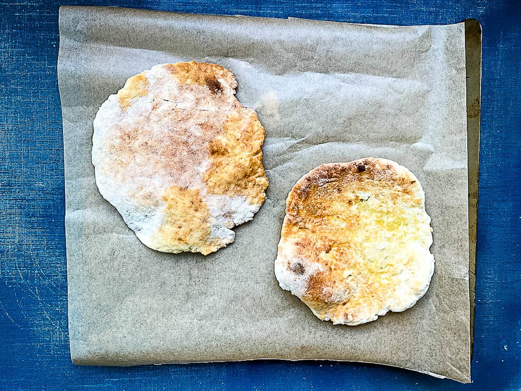 two grilled flatbreads on baking tray or cookie sheet