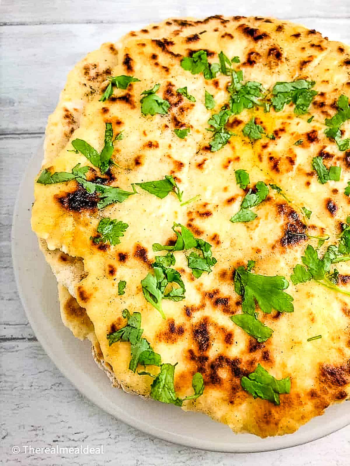 3 ingredient flatbread topped with garlic butter and parsley