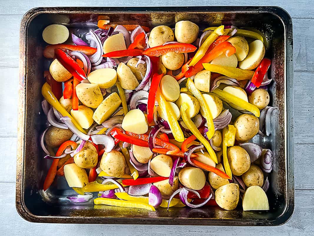 potatoes red onion and bell peppers in roasting tray