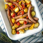 sausage tray bake cooked with potatoes and tomatoes in tray