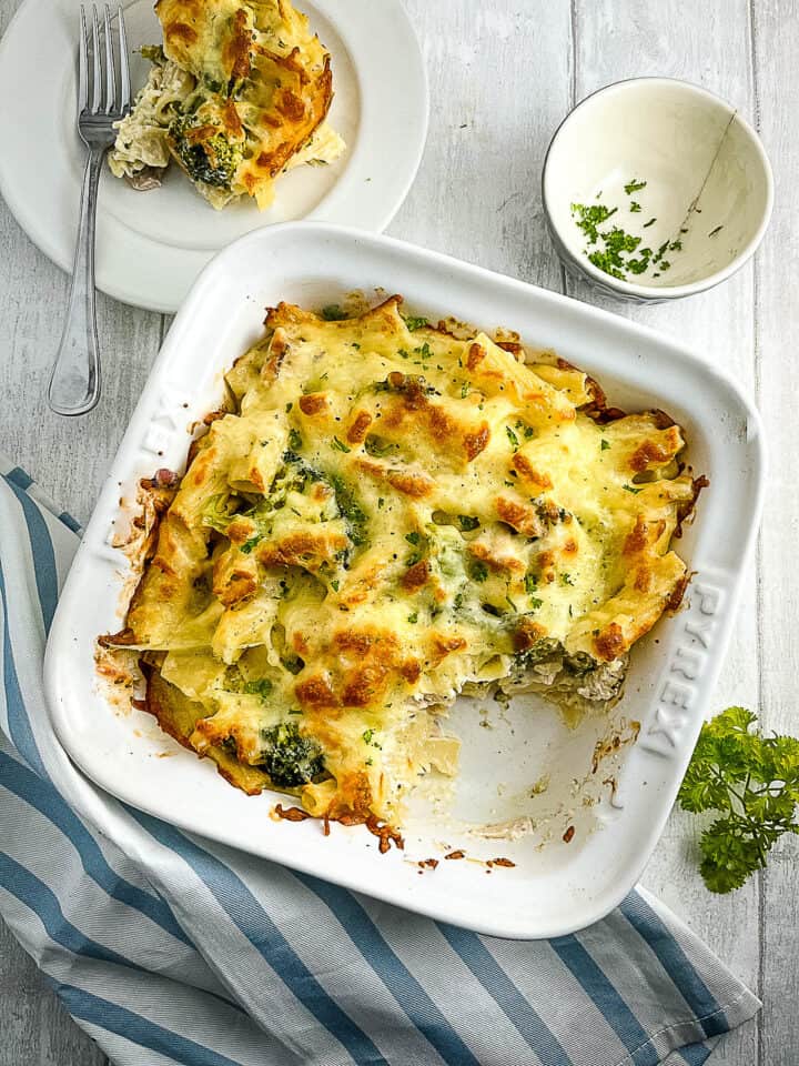 chicken and broccoli pasta bake in oven proof dish with portion removed