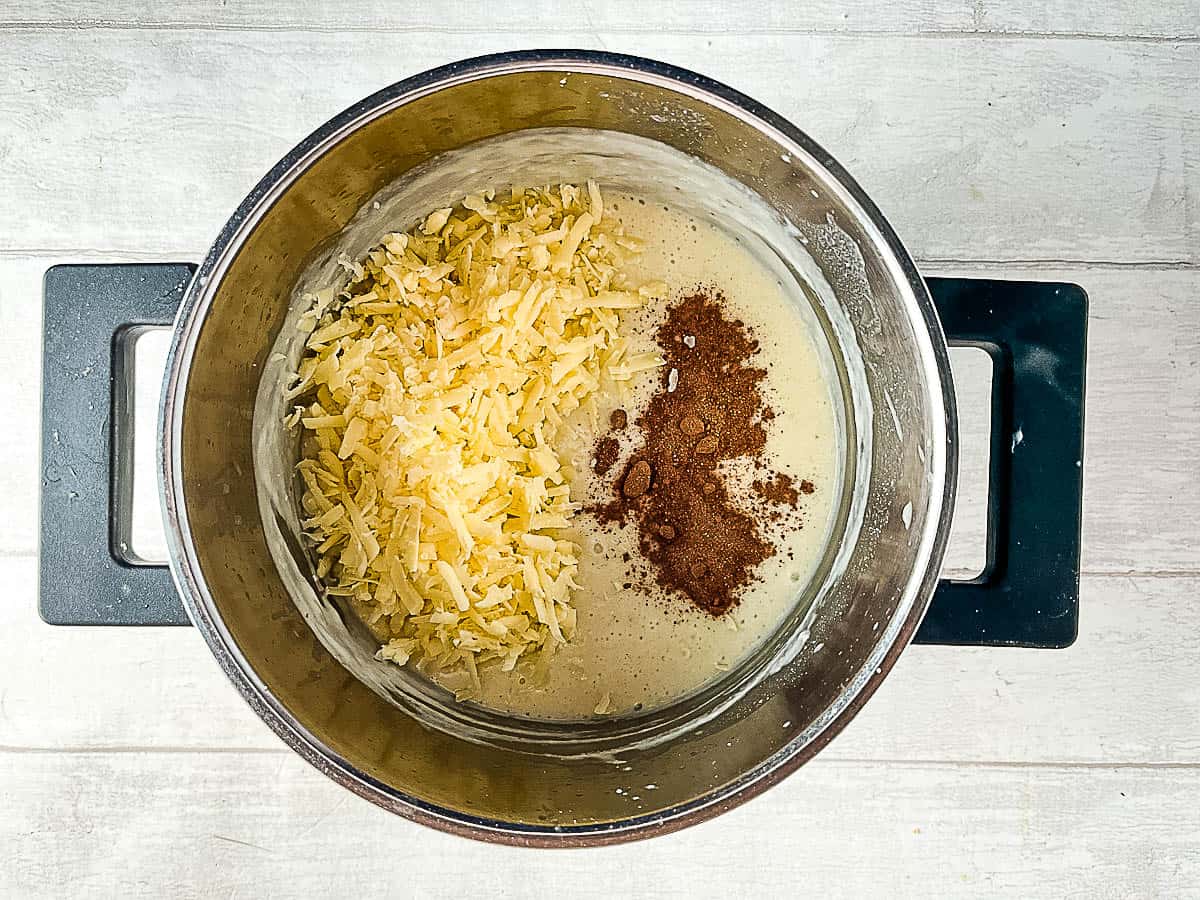 grated or shredded cheese and nutmeg added to white sauce