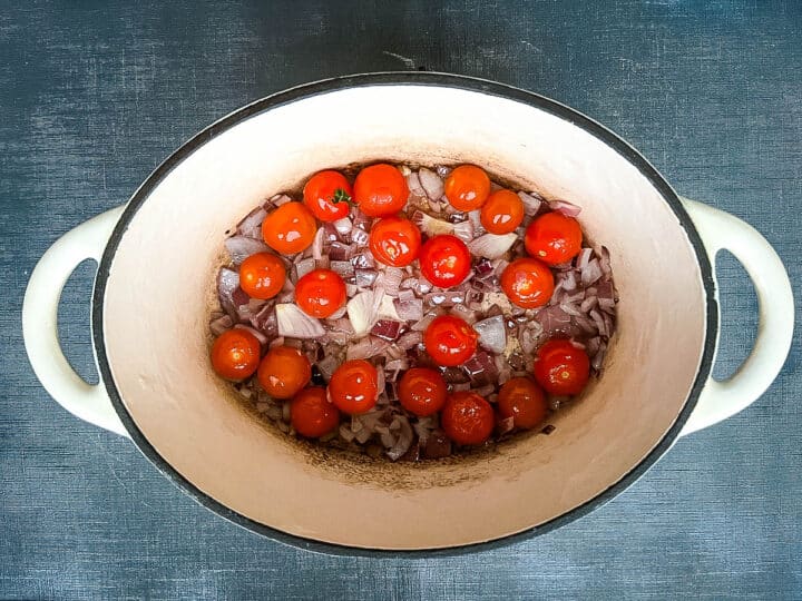 red onion and cherry tomatoes in pan
