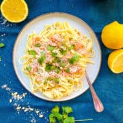 smoked salmon pasta carbonara no cream served on a plate with parmesan cheese and parsley