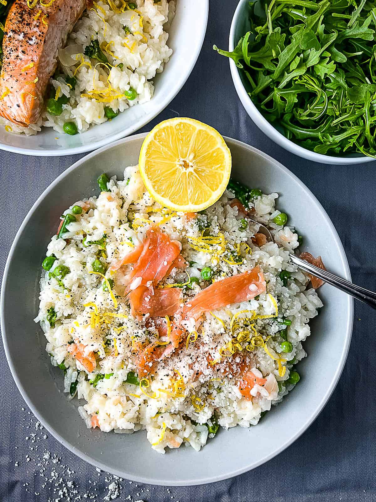 smoked salmon risotto finished dish topped with grated parmesan cheese and lemon zest