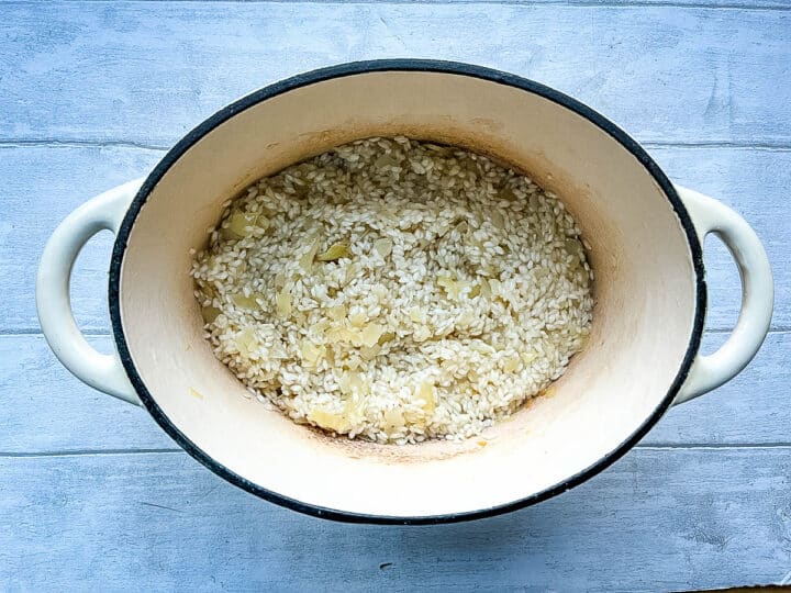 arborio risotto rice frying in pan with onions