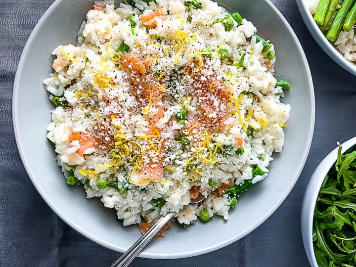 smoked salmon risotto finished dish served with lemon zest and parmesan cheese